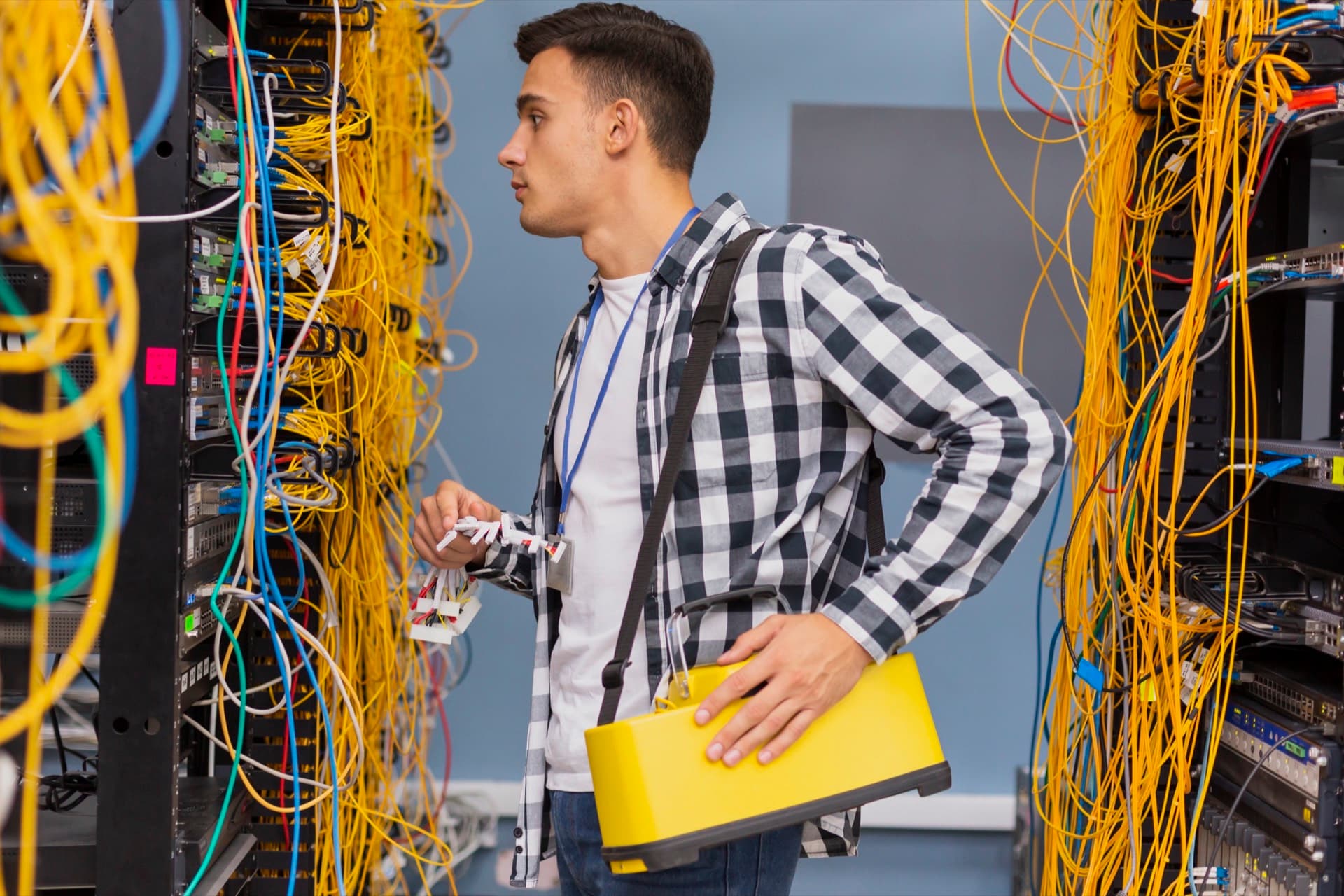 Network engineer inspecting Ethernet switches